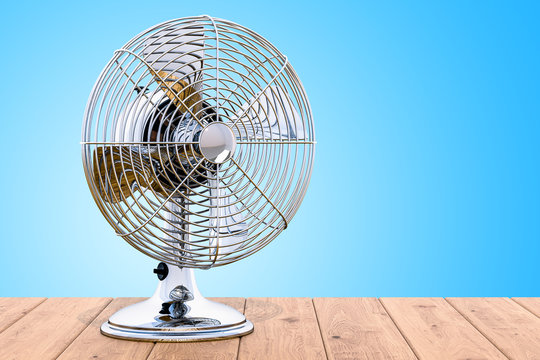 Vintage Table Fan on the wooden table, 3D rendering