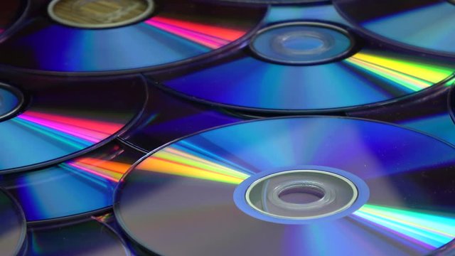 Rotating colorful shiny many DVD compact discs background