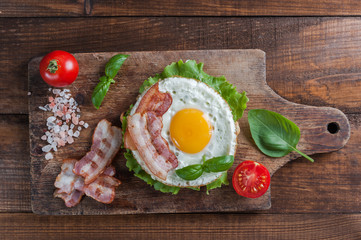Fried egg and bacon on board