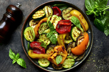 Grilled vegetables (  colorful bell pepper, zucchini, eggplant ) with basil and dry herbs.Top view.