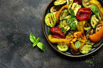 Grilled vegetables (  colorful bell pepper, zucchini, eggplant ) with basil and dry herbs.Top view.