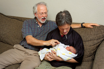 Grandfather of Newborn Baby Helps his Brother in Law with Downs Syndrome Hold the Infant