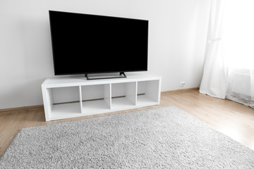 Lcd tv on white shef at modern room interior