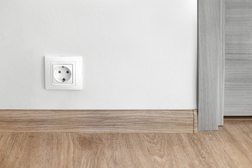 Electric socket mounted on wall at modern flat