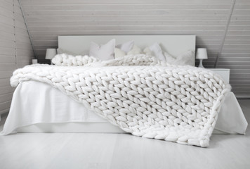 Fototapeta White nordic bedroom interior with knit plaid obraz