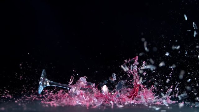 Super slow motion of falling glass of red wine, isolated on black background. Filmed on high speed cinema camera, 1000 fps.