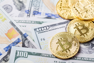 Bitcoins on dollar banknotes background
