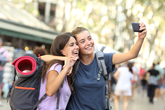 Backpacker friends taking selfie with a phone