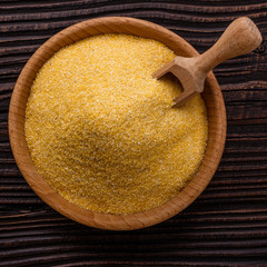 raw Italian corn porridge polenta on a rustic wooden background