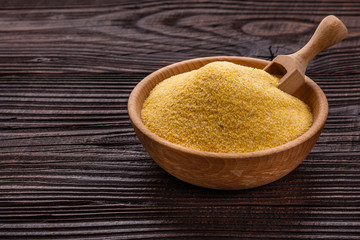 raw Italian corn porridge polenta on a rustic wooden background