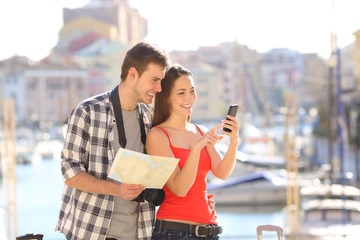 Couple of tourists checking online information on vacation