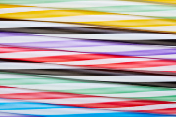 Striped, colored tubes for cocktails. Colorful background.