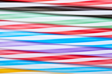 Striped, colored tubes for cocktails. Colorful background.