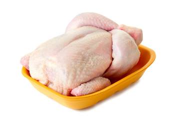 Raw chicken in retail tray on wh
