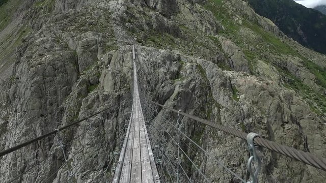Walk through Trift Bridge, around lake, glacier and mountains, national park Switzerland, Europe. Summer landscape, sunshine weather and sunny day