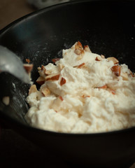 Sprinkling Almonds on Burrata
