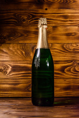 Bottle of the champagne on wooden table