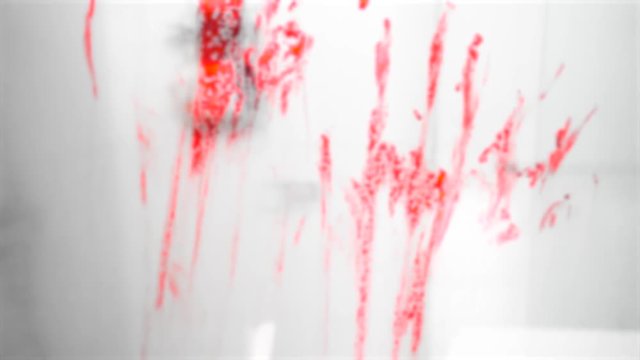 Scary bloody hand prints on the mirror. Halloween concept. Shot in 4k resolution