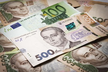 concept of hryvnia banknotes together with foreign currency close-up.background copy space