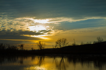 Bright Orange Sunset Over Calm River 
