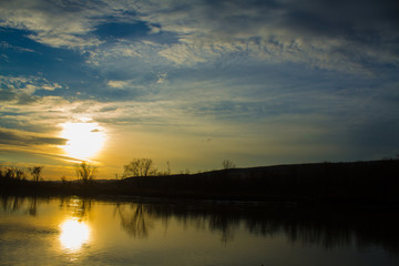 Bright Orange Sunset Over Calm River 