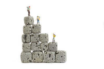 miniature people with cube rock on white background
