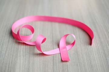 Breast Cancer Awareness, Pink Ribbon on wooden background for supporting people living and illness. Woman Healthcare and World cancer day concept