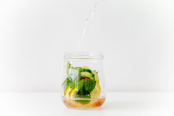 Summer drink coctail in glass jar, berries and mint on wooden table