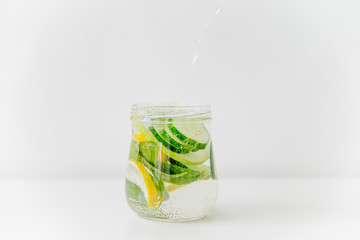 Summer drink coctail in glass jar, berries and mint on wooden table