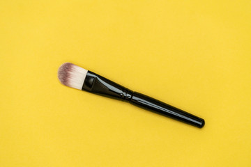 Makeup brush with yellow background