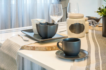 Pottery tableware setting on dining table, mug, bowl and jar