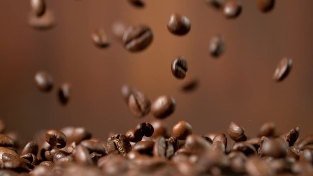 Roasted coffee beans falling down in super slow motion. Shooted with high speed cinema camera.