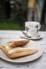 cup of coffee and sandwiches on wooden table