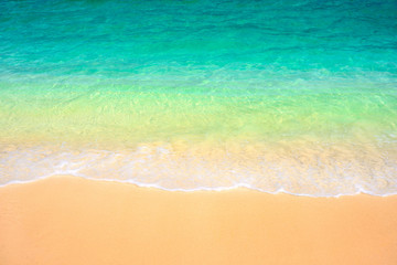 Fototapeta na wymiar Soft bubble green wave on sandy beach.