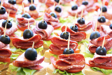Canapés with sausage slice and olive