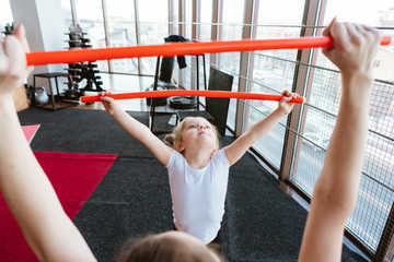 Little girl and mom doing exercises with sticks