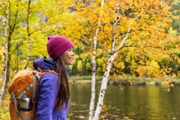 Woman hiker hiking looking at scenic view of fall foliage mountain landscape . Adventure travel...