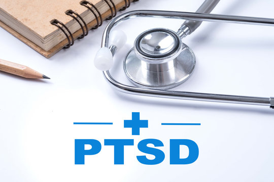 Stethoscope, notebook and pencil with PTSD - post traumatic stress disorder words. Medical concept. War veteran mental health issue.