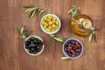 Overhead photo of various olives and olive oil with copy space