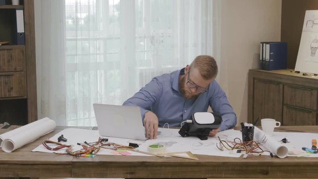 Software engineer programming VR headset
