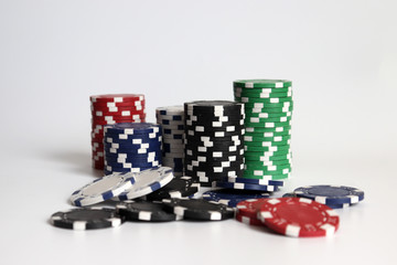 The pile of casino chips on the white background.