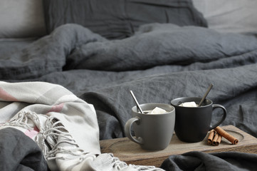 Two coffee mug in dark grey bed