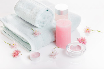 Fototapeta na wymiar Spa concept in Valentine's Day, Birthday Day, pink peony, candles, blue towels, flowers. Spring or summer background