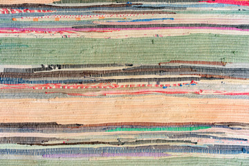 multi-colored hand-made carpet from fabric.