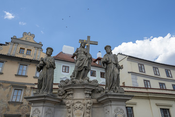 Fototapeta na wymiar Sculpture of Holy Savior with Cosmas and Damian on the Charles Bridge in Prague. Czech Republic.