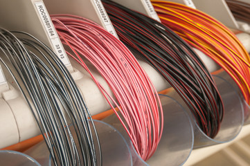 Colored ties on white background, cables