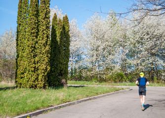 Obraz premium The man is running through the park.