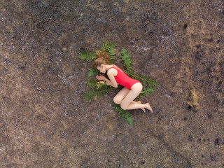 The girl lies on the scorched earth