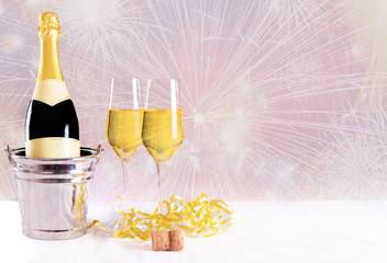 Champagner Flasche mit Gläsern vor einem bunten unscharfem Hintergrund mit Feuerwerk