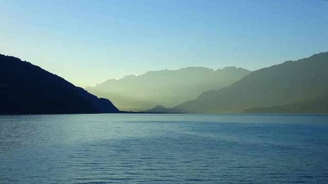 Time lapse view lake Thun (Thunersee) and mountains of Swiss Alps in city Spiez, Switzerland, Europe. Summer landscape, sunshine weather, blue sky and sunny day